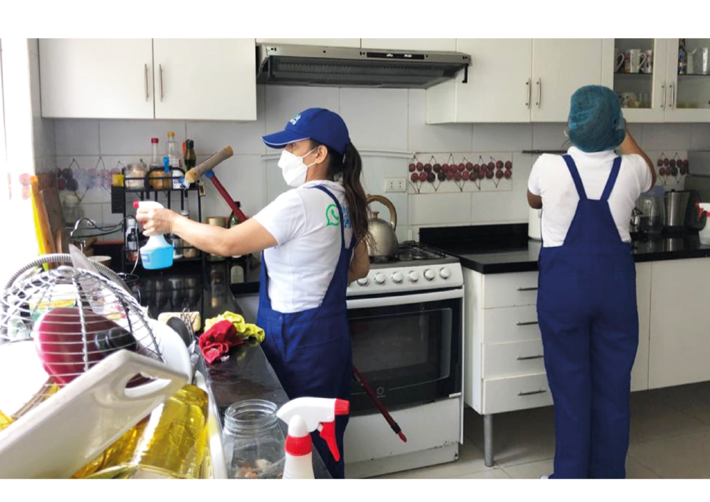 Limpieza de cocina Dos personas realizando limpieza en la cocina Dos mujeres realizando limpieza en la cocina